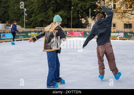 Harrogate Ice Skating rink with ice skaters and people enjoying the winter event and Christmas attraction. Stock Photo