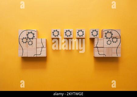 Human head outline on wooden blocks, sharing ideas, knowledge and information Stock Photo