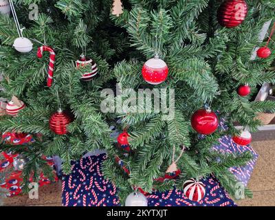 Closeup of Christmas decorations hanging in a Christmas tree. Stock Photo