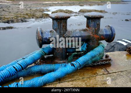 Ship's double mooring bollard with blue ropes attached Stock Photo