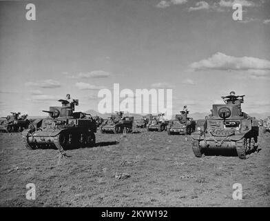 A vintage photo circa March 1943 of American built M3 Stuart light tanks on maneuvers in Australia during World War 2. These vehicles were provided under the lend lease scheme. Stock Photo