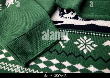closeup of green christmas sweater fabric texture. warm winter clothing Stock Photo