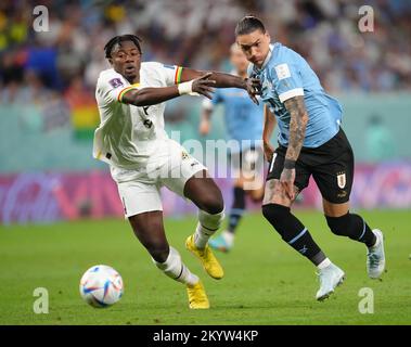 Uruguay's Darwin Nunez (right) and Ghana's Mohammed Salisu battle for the ball during the FIFA World Cup Group H match at the Al Janoub Stadium in Al-Wakrah, Qatar. Picture date: Friday December 2, 2022. Stock Photo