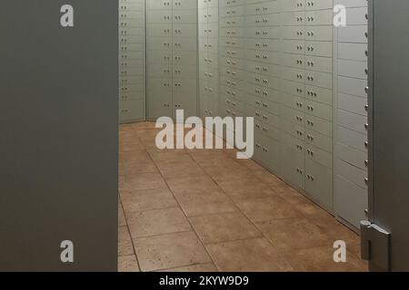 Storage with individual deposit grey cells boxes in the bank and brown floor Stock Photo