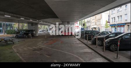 STUTTGART, 2022 november 08; cityscape with almost empty parking under urban highway flyover in city center, shot in bright fall light on november 08, Stock Photo