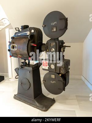 Original old big movie reel for 35 mm film projector film loaded detail on  neutral background Stock Photo - Alamy