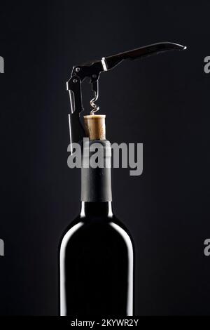 Corkscrew opening bottle of wine Stock Photo