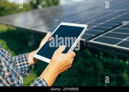 Engineer working at floating solar farm. Solar panels checking the panels at solar energy installation Stock Photo