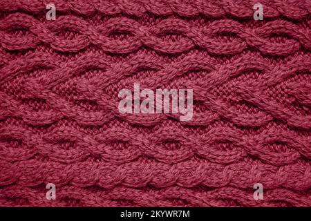 magenta cable knit sweater pattern. Cozy nordic background. Ornate wool texture Stock Photo