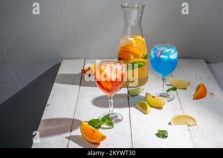 Many different cocktails on a light background. Mixology and nightlife concept. Colored alcoholic and non-alcoholic cocktails Stock Photo