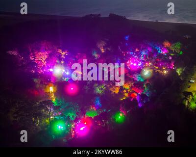 Abbotsbury, Dorset, UK.  2nd December 2022.  View from the air at dusk of the Abbotsbury Subtropical Gardens at Abbotsbury in Dorset which are illuminated with colourful lights during December for their Illuminate event.  Picture Credit: Graham Hunt/Alamy Live News Stock Photo