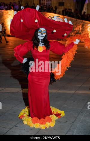 Woman with face painted & dressed as La Catrina for a costume competition for Day of the Dead celebration in Oaxaca, Mexico. Stock Photo