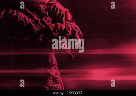 Special forces soldier with rifle on dark background. Color of the year 2023, viva magenta. Stock Photo