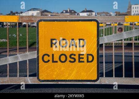 Orange road closed sign on a metal gate. Stock Photo