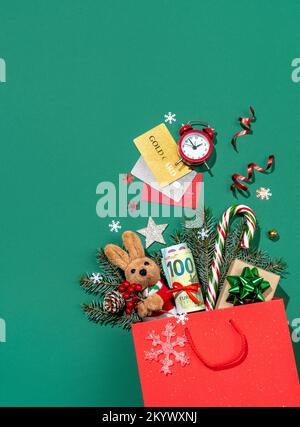 Holiday explosion from shopping bag on green background. Merry Christmas and Happy New Year concept Stock Photo