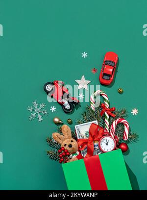 Holiday explosion from gift box on green background. Merry Christmas and Happy New Year concept Stock Photo