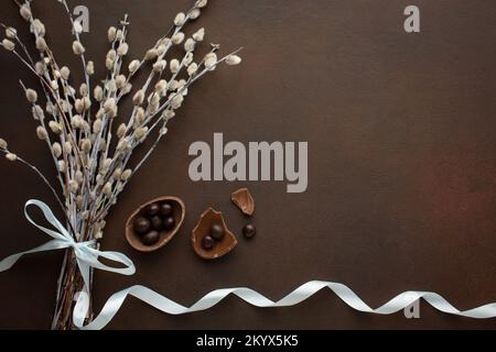 Easter greeting card with chocolate eggs and colorful candies. Stock Photo