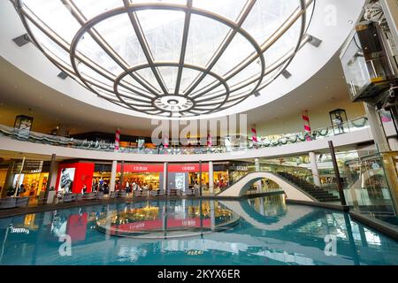 SINGAPORE - NOVEMBER 08, 2015: view on Rain Oculus. Rain Oculus is a large whirlpool forms inside a 70 foot diameter acrylic bowl and falls 2 stories Stock Photo