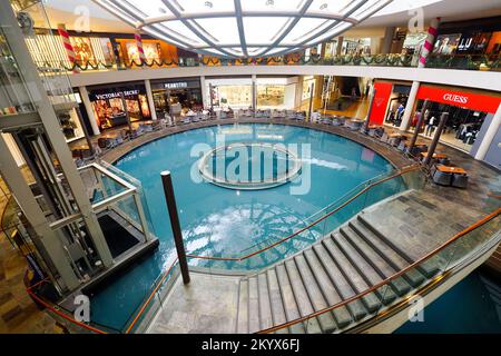 SINGAPORE - NOVEMBER 08, 2015: view on Rain Oculus. Rain Oculus is a large whirlpool forms inside a 70 foot diameter acrylic bowl and falls 2 stories Stock Photo