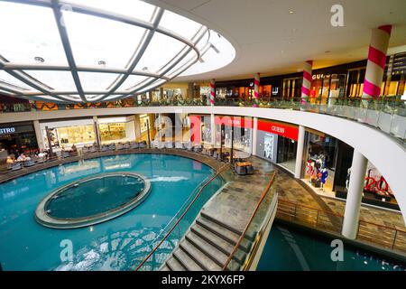 SINGAPORE - NOVEMBER 08, 2015: view on Rain Oculus. Rain Oculus is a large whirlpool forms inside a 70 foot diameter acrylic bowl and falls 2 stories Stock Photo