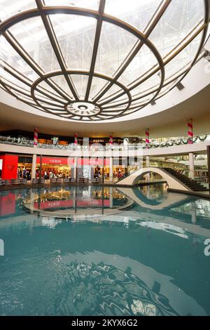 SINGAPORE - NOVEMBER 08, 2015: view on Rain Oculus. Rain Oculus is a large whirlpool forms inside a 70 foot diameter acrylic bowl and falls 2 stories Stock Photo