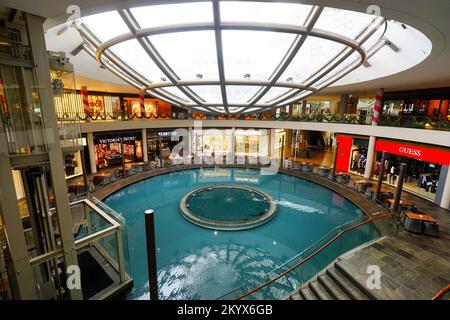 SINGAPORE - NOVEMBER 08, 2015: view on Rain Oculus. Rain Oculus is a large whirlpool forms inside a 70 foot diameter acrylic bowl and falls 2 stories Stock Photo