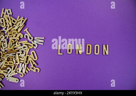 purple background with a pile of wooden capital letters spilling into ...