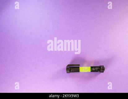 top view of a single green and black spirit or line level isolated on a purple background Stock Photo