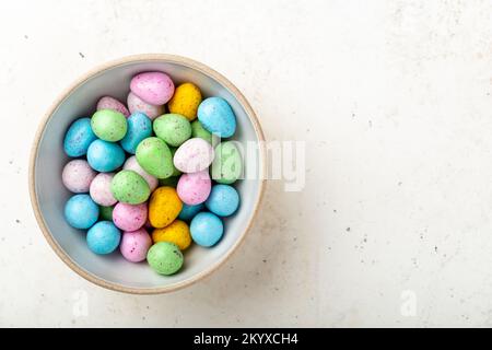 Heap of colorful chocolate eggs in a ceramic bowl Stock Photo