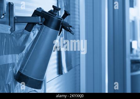 Plastic bottles with car spray hanging on the wall in auto repair shop Stock Photo