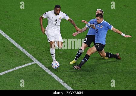 Doha, Qatar. 02nd Dec, 2022. Jordan Ayew of Ghana disputes the bid with Guillermo Varela and Sebastian Coates of Uruguay, during the match between Ghana and Uruguay, for the 3rd round of Group H of the FIFA World Cup Qatar 2022, Al Janoub Stadium this Friday 02. 30761 (Heuler Andrey/SPP) Credit: SPP Sport Press Photo. /Alamy Live News Stock Photo