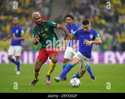 Cameroon's Eric Maxim Choupo-Moting (left) and Brazil's Gabriel Martinelli battle for the ball during the FIFA World Cup Group G match at the Lusail Stadium in Lusail, Qatar. Picture date: Friday December 2, 2022. Stock Photo
