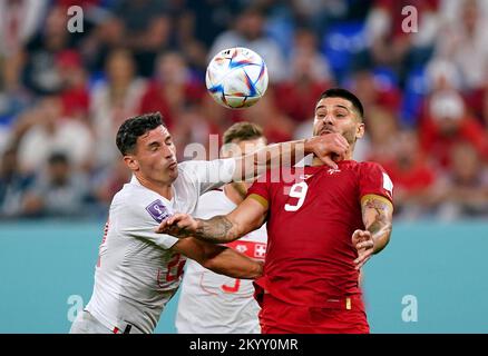 Switzerland's Fabian Schaer (left) and Serbia's Aleksandar Mitrovic battle for the ball during the FIFA World Cup Group G match at Stadium 974 in Doha, Qatar. Picture date: Friday December 2, 2022. Stock Photo