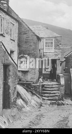 Vintage photograph - 1924 - Gorl on steps of Old Smuggler's Cottage, Polperro, Cornwall Stock Photo