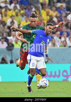 Lusail, Qatar. 2nd Dec, 2022. Rodrygo (R) of Brazil vies with Pierre Kunde of Cameroon during their Group G match at the 2022 FIFA World Cup at Lusail Stadium in Lusail, Qatar, Dec. 2, 2022. Credit: Chen Cheng/Xinhua/Alamy Live News Stock Photo