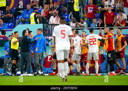Switzerland manager Murat Yakin exchanges words with a member of the Serbia coaching staff during the FIFA World Cup Group G match at Stadium 974 in Doha, Qatar. Picture date: Friday December 2, 2022. Stock Photo