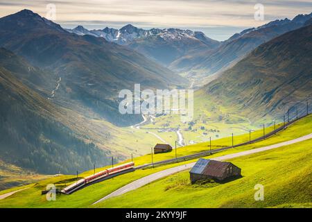 Swiss train in the idyllic alps around Andermatt, Uri, Switzerland Stock Photo