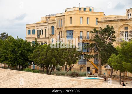 Valletta, Malta- November 12, 2022: Hastings Garden and  typical residential buildings made of stone with wooden balconies and shutters Stock Photo