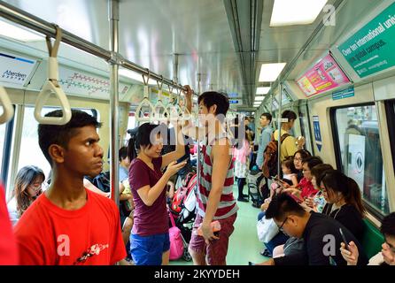 SINGAPORE - NOVEMBER 07, 2015: passengers in MRT train. The Mass Rapid Transit, or MRT, is a rapid transit system forming the major component of the r Stock Photo