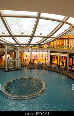 SINGAPORE - NOVEMBER 08, 2015: view on Rain Oculus. Rain Oculus is a large whirlpool forms inside a 70 foot diameter acrylic bowl and falls 2 stories Stock Photo