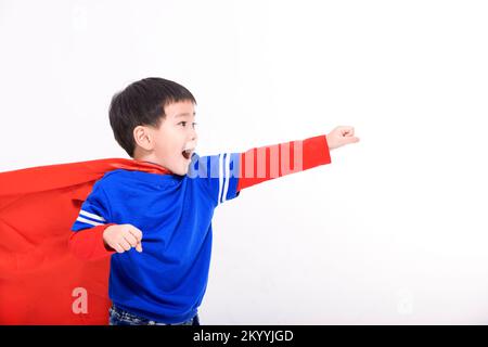 Happy Little boy in red super hero cape and mask Stock Photo