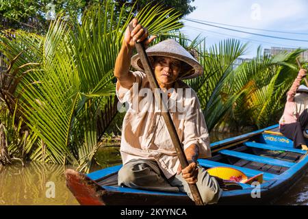 Ho Chi Minh City, Vietnam- November 9, 2022: Tourism rowing boat in the Mekong delta. Tours on Paddle boats, tourist attraction on the Mekong River. M Stock Photo