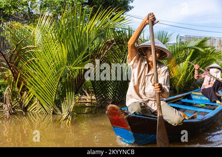 Ho Chi Minh City, Vietnam- November 9, 2022: Tourism rowing boat in the Mekong delta. Tours on Paddle boats, tourist attraction on the Mekong River. M Stock Photo