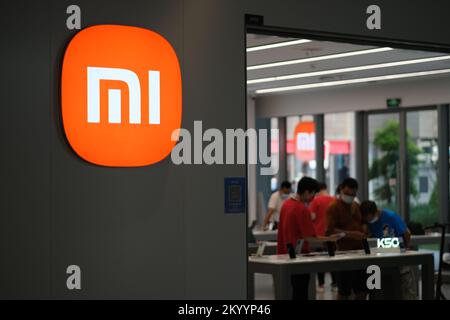 Shanghai,China-August 13th 2022:  close up Xiaomi retail store logo and blur customers in store. Xiaomi is a Chinese electronic company Stock Photo