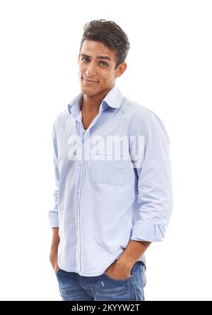 Smiling skepticism. Portrait of a handsome young man standing with hands in his pockets against a white background. Stock Photo