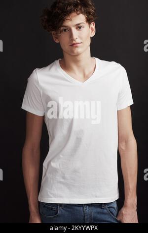 Giving off the eagerness of youth. A handsome young man smiling at you while posing in studio. Stock Photo