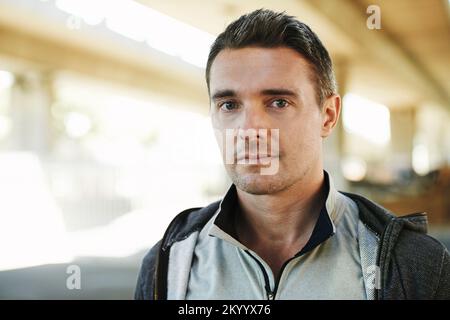 He stays in shape to boost his health. Portrait of a fit young man wearing a tracksuit. Stock Photo