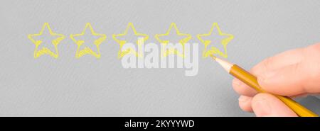 Customer rating with hand drawn stars. Positive customer feedback. Hand writing yellow five star to customer evaluation service and product. Marketing Stock Photo
