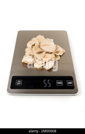 Sliced dried shallots on a scale isolated over white Stock Photo