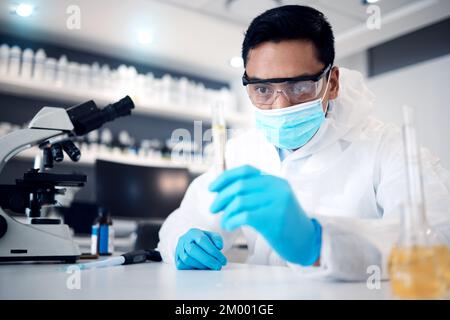 Scientist, research and man work in lab for science innovation in chemistry or physics, microscope and test tube for scientific experiment. Face mask Stock Photo